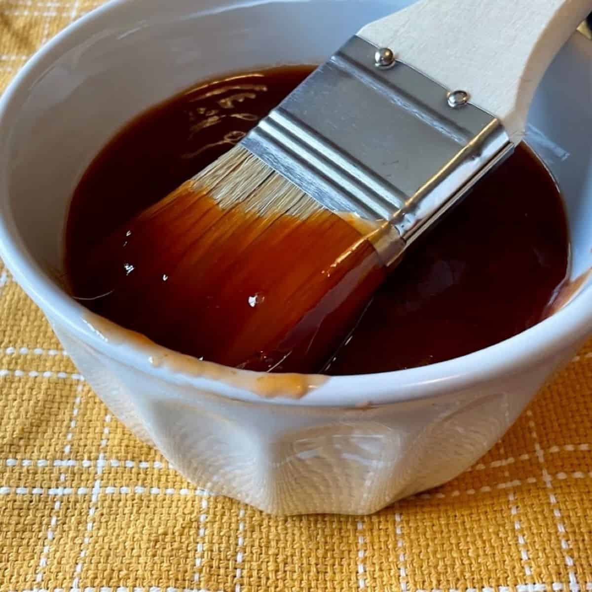 BBQ sauce with brush in bowl