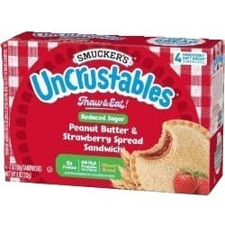 Uncrustable reduced sugar peanut butter & strawberry jam on wheat bread